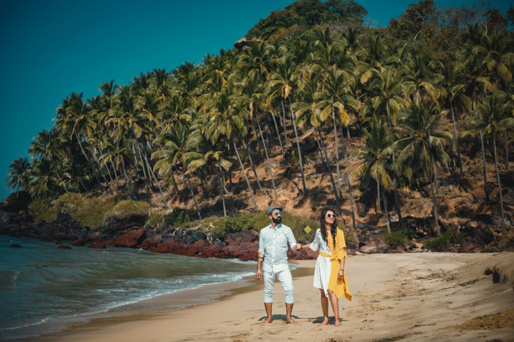 couple standing holding hanfd at river's bank